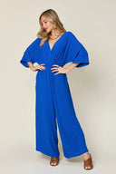 Surplice wide-leg jumpsuit with pockets, sizes S through 3XL, in a jumpsuit vs romper comparison