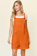 Tangerine textured sleeveless plus size romper with a relaxed leg